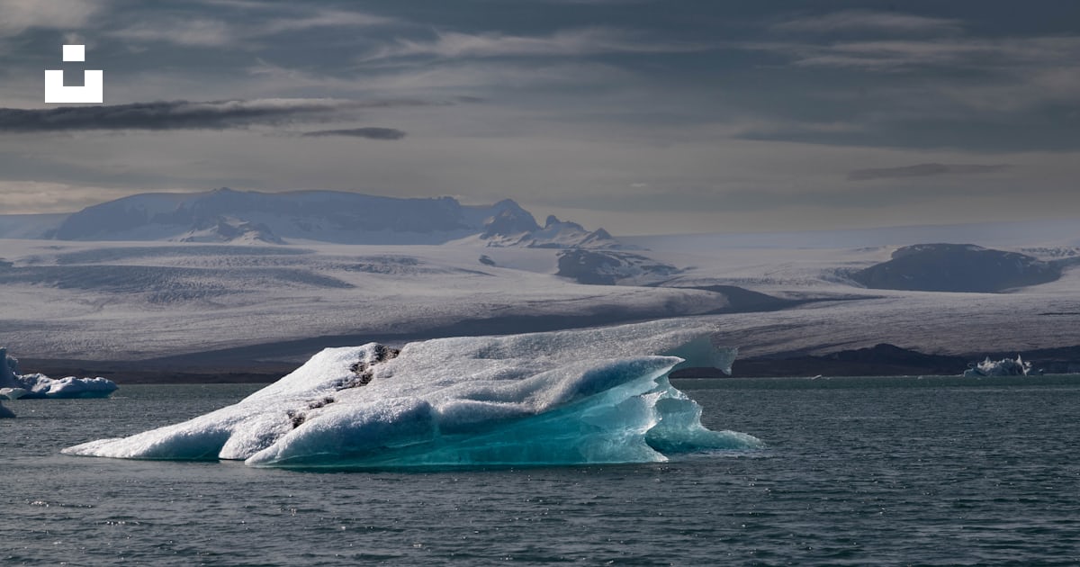 Foto Un gran iceberg flotando sobre un cuerpo de agua – Imagen Útsýni