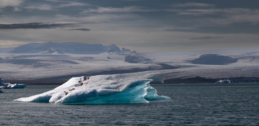 a large iceberg floating on top of a body of water