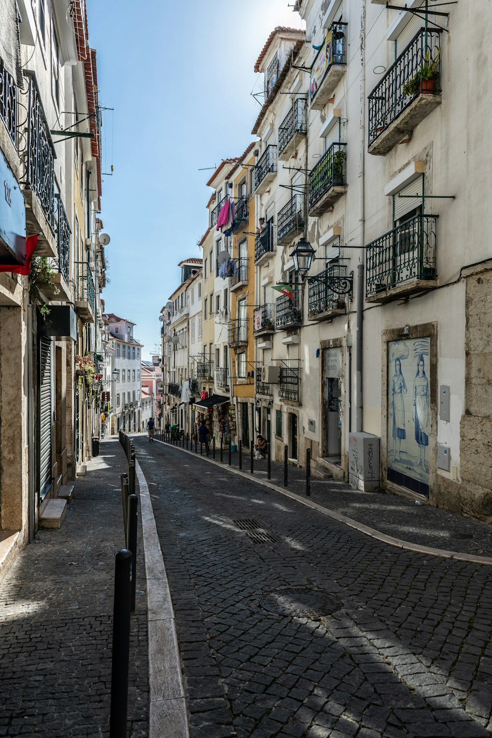 an empty street in a city with buildings and balconies