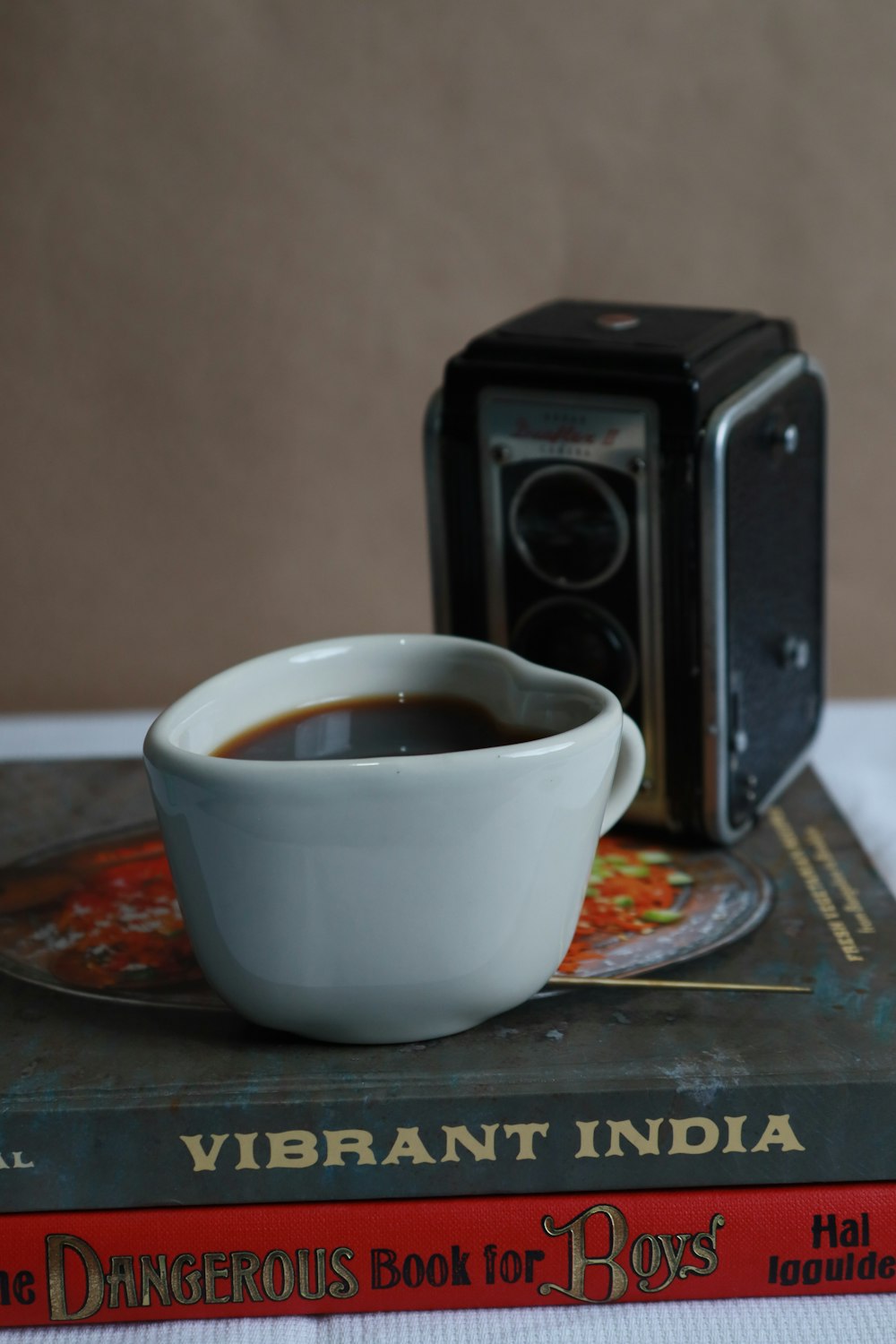 a cup of coffee sitting on top of a book