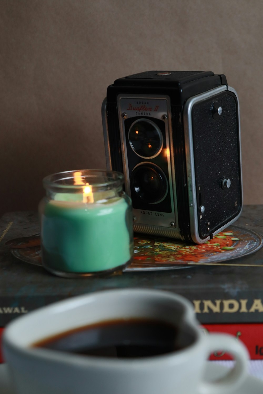 a cup of coffee and a camera on a table