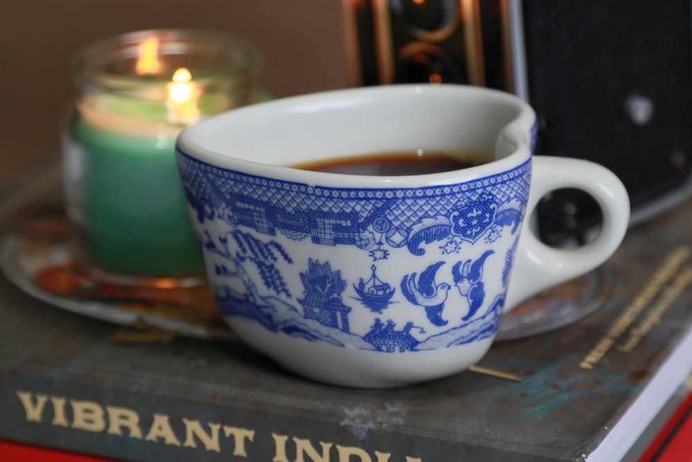 a cup of coffee sitting on top of a book