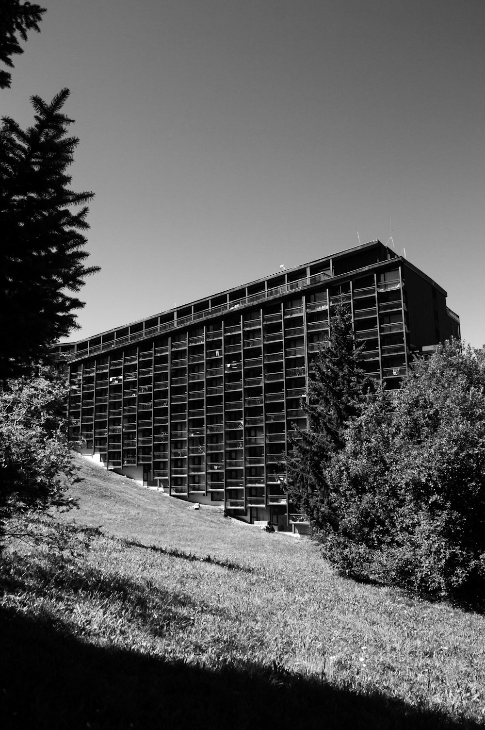 a large building sitting on top of a lush green field