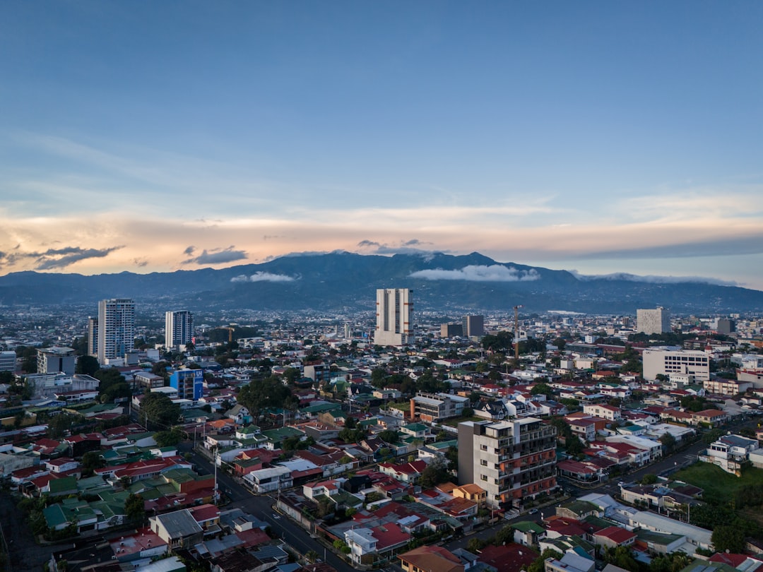 a view of a city with a mountain in the background, Aerial views of San José, Costa Rica in the morning