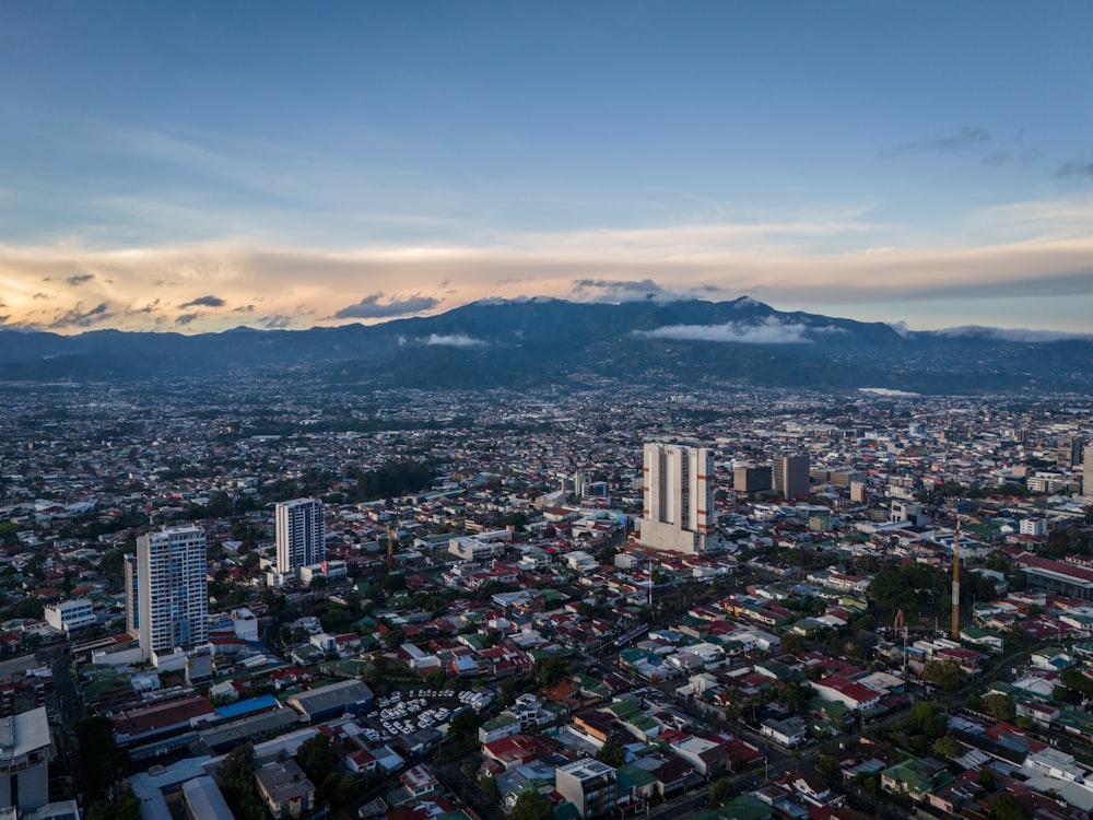 an aerial view of a city with mountains in the background