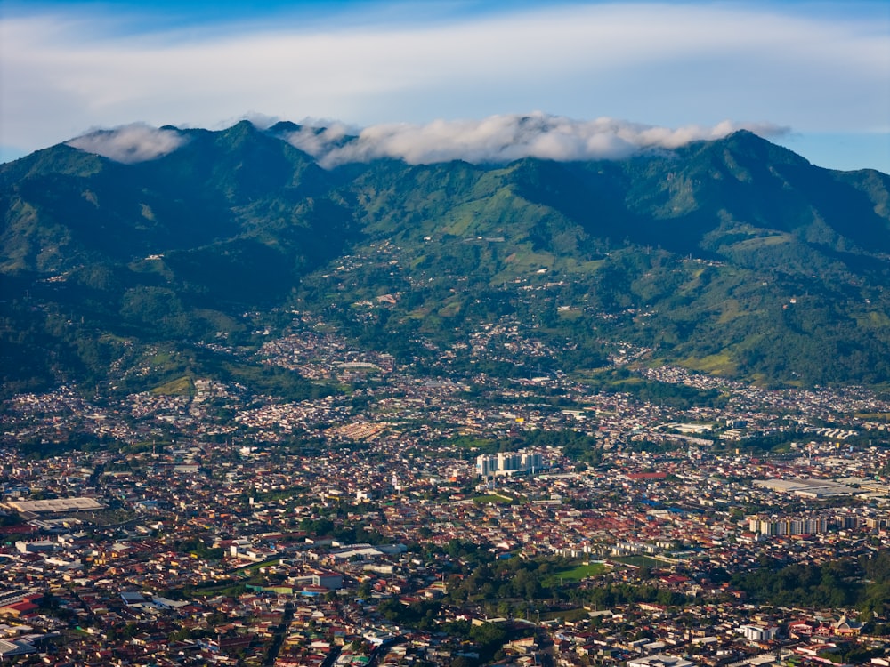 an aerial view of a city with mountains in the background