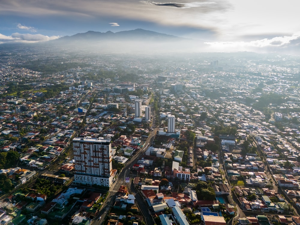 an aerial view of a city with mountains in the background