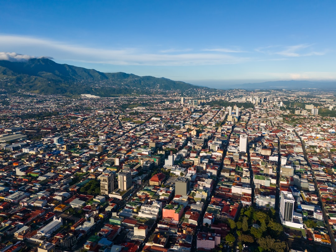 an aerial view of a city with mountains in the background, Aerial views of San José, Costa Rica in the morning