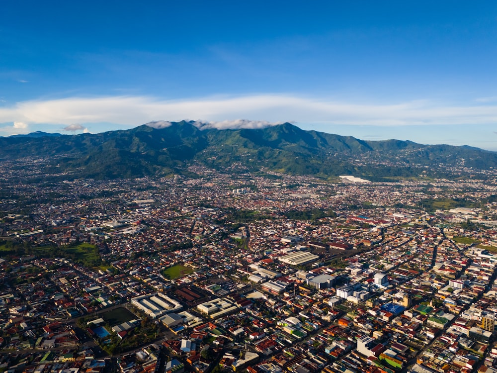 an aerial view of a city with mountains in the background