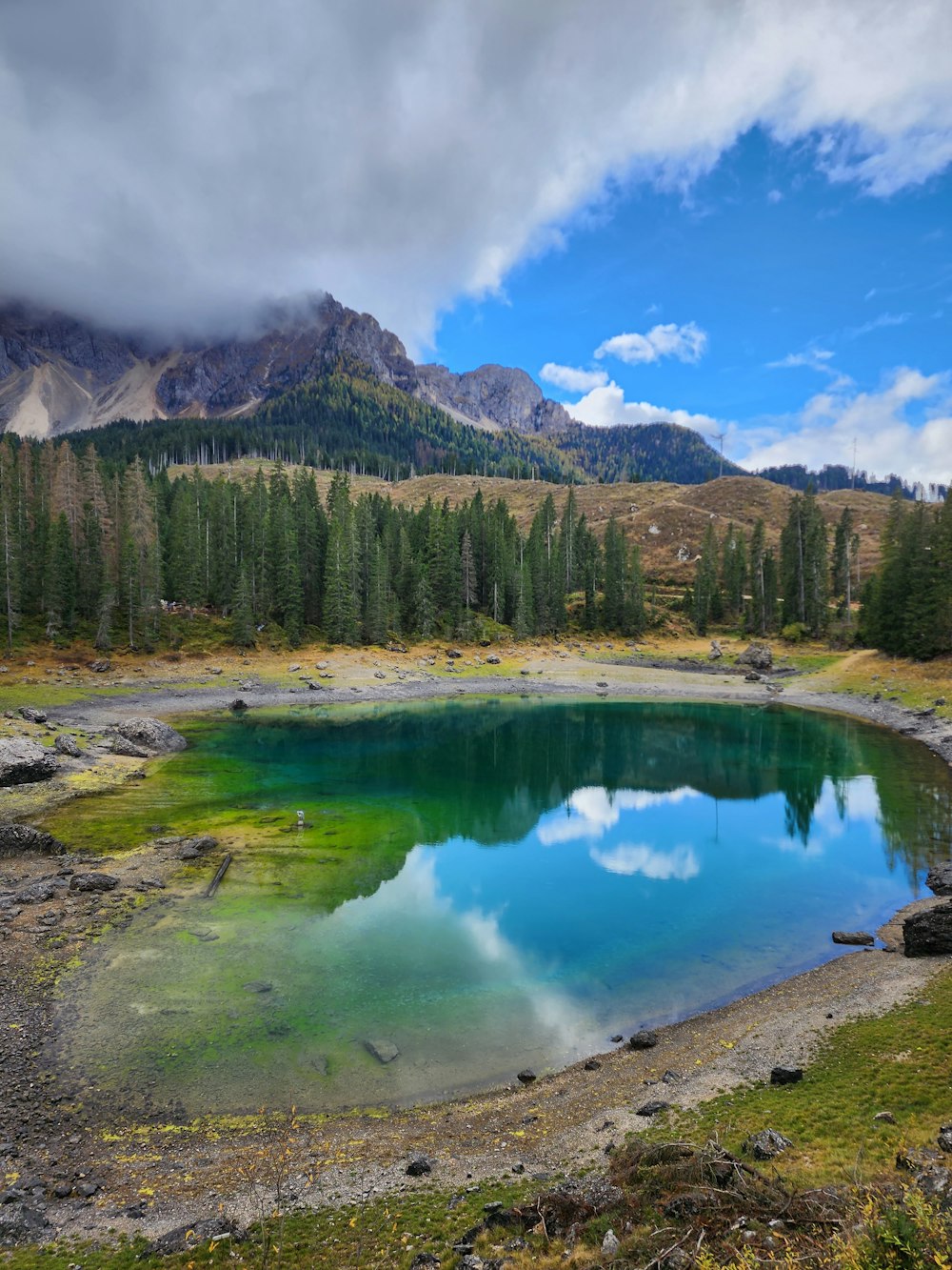 a blue lake surrounded by mountains and trees