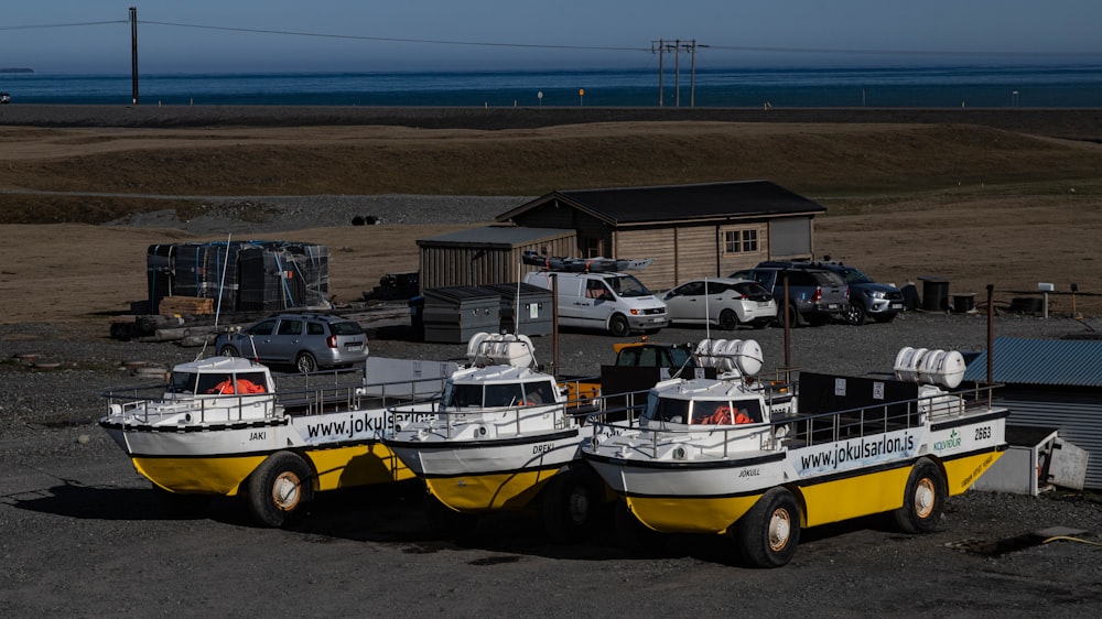 a couple of boats parked next to each other in a parking lot