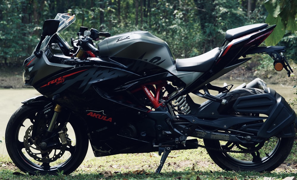 a black motorcycle parked in a grassy area