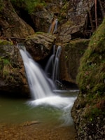 A picturesque waterfall cascading down moss-covered rocks.