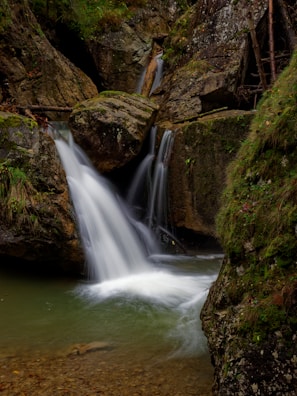A picturesque waterfall cascading down moss-covered rocks.