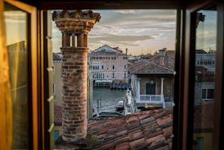 Charming Venetian canal view from a bright vacation home window.