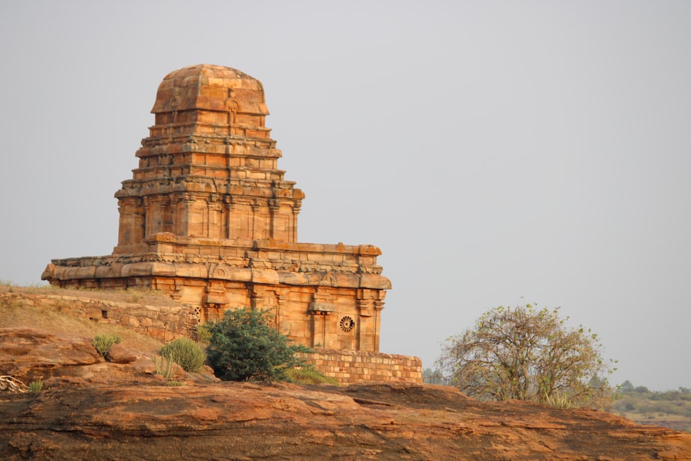 a large stone structure sitting on top of a hill