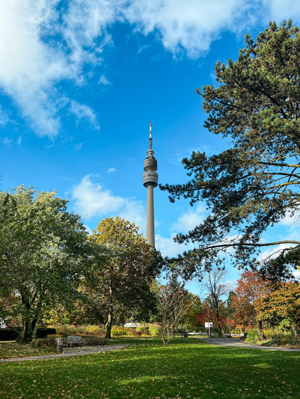 a tall tower towering over a lush green park