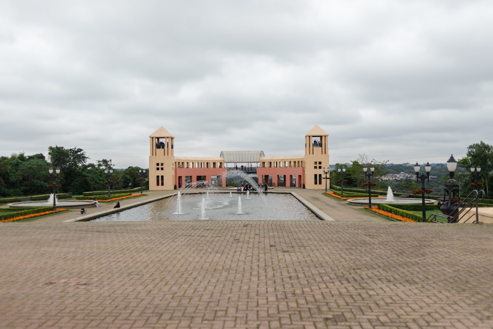 a large building with a fountain in front of it