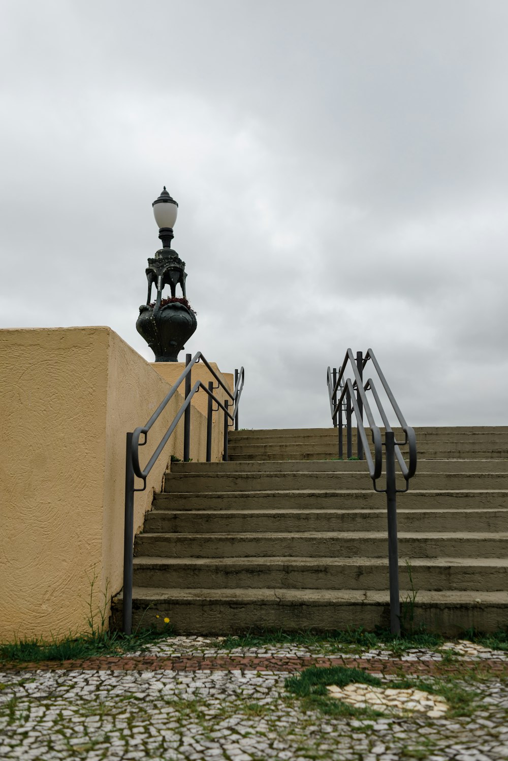 a street light sitting on top of a set of stairs