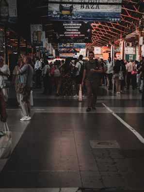 A busy market scene with banners announcing special deals and discounts.