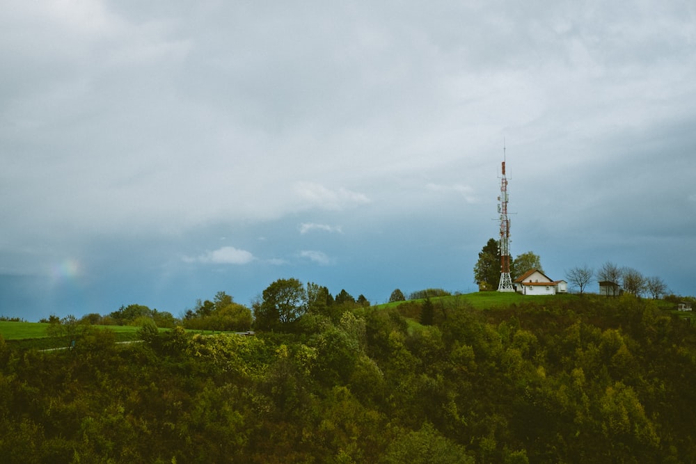 a house on a hill with a radio tower in the background