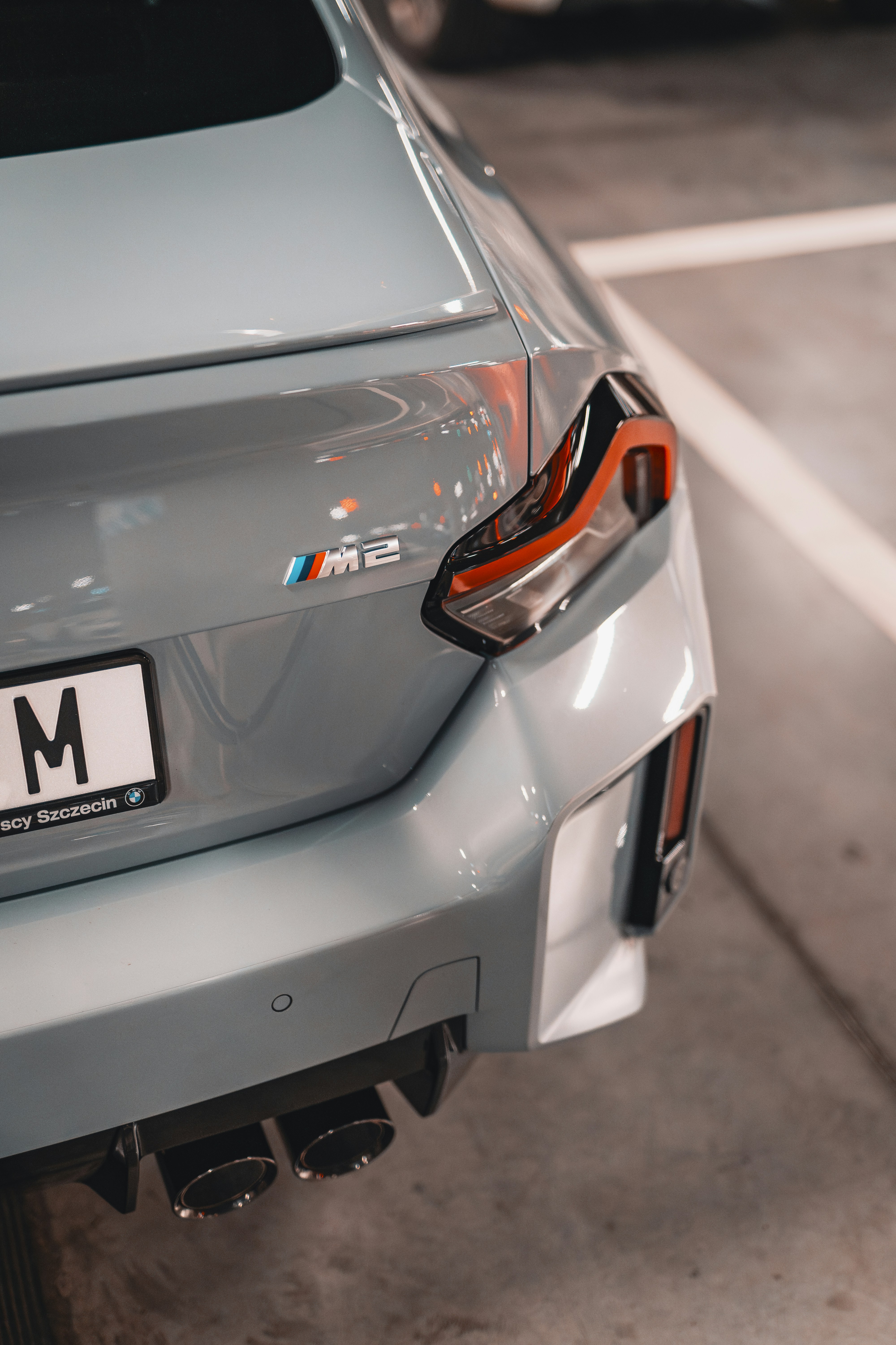 a close up of a bmw car parked in a parking lot