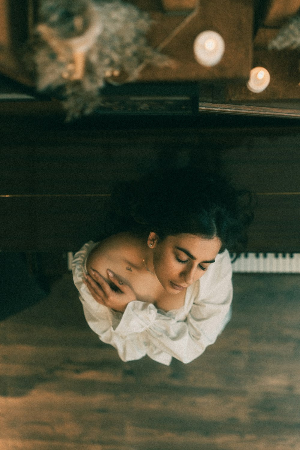 a woman sitting at a piano looking down