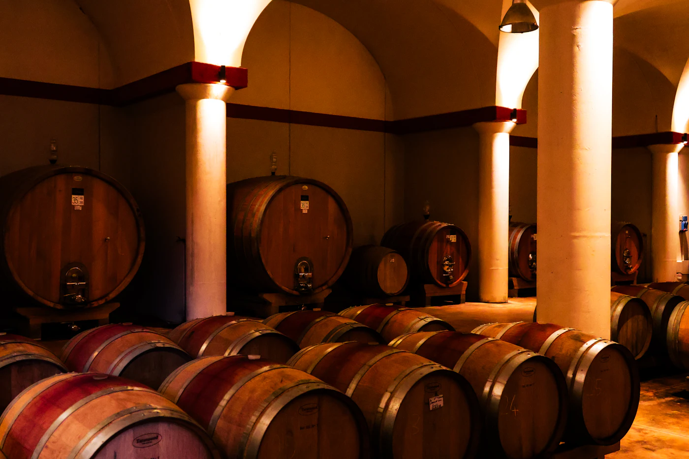 Large botti and barriques in a wine cellar