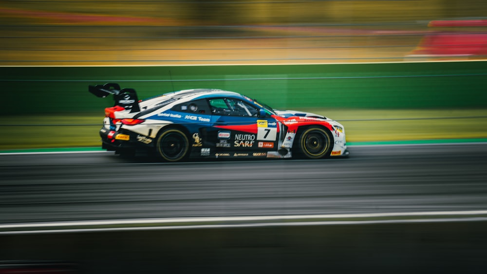 a car driving on a race track with blurry background