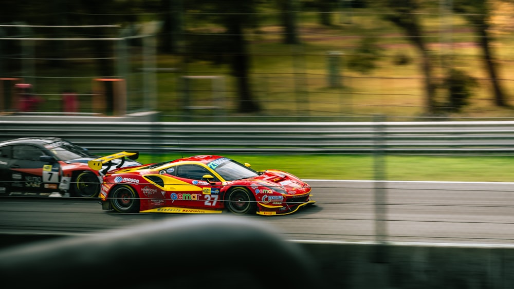 a red and yellow car driving down a race track