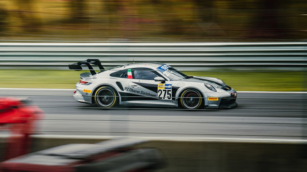 a car driving down a race track in the rain