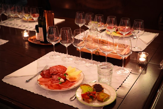 An elegant table setting with drinks and appetizers at a stylish event.