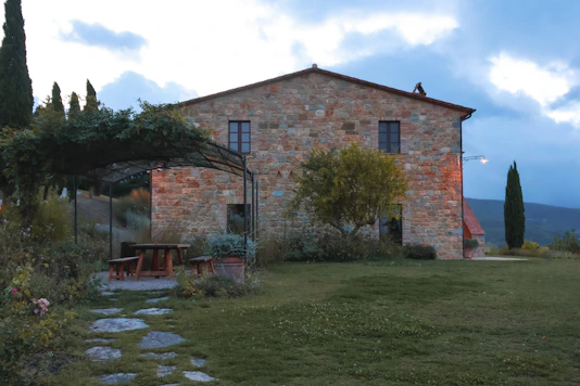 a stone house with a stone pathway leading to it