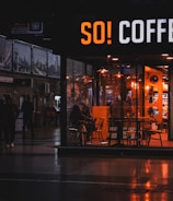 A cozy café filled with happy patrons drinking coffee.