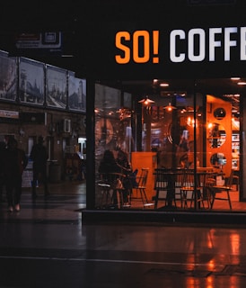 A cozy coffee shop scene with warm lighting.