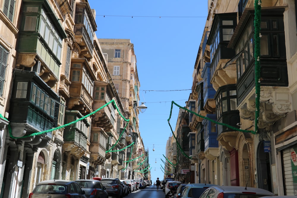 a city street filled with lots of traffic next to tall buildings