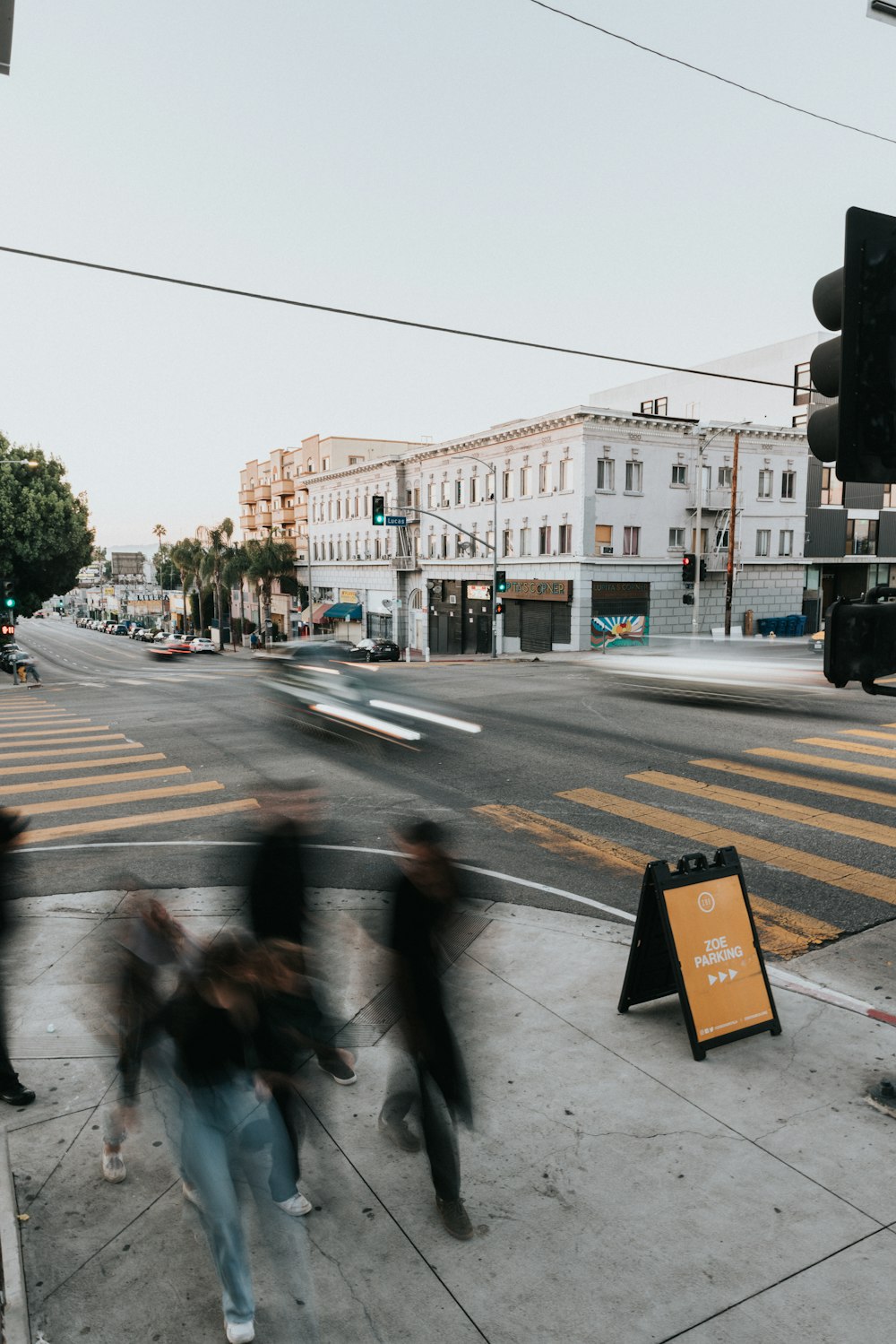 a group of people walking across a street