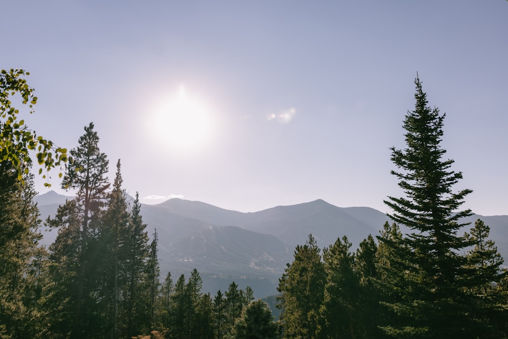 the sun is shining over a mountain range