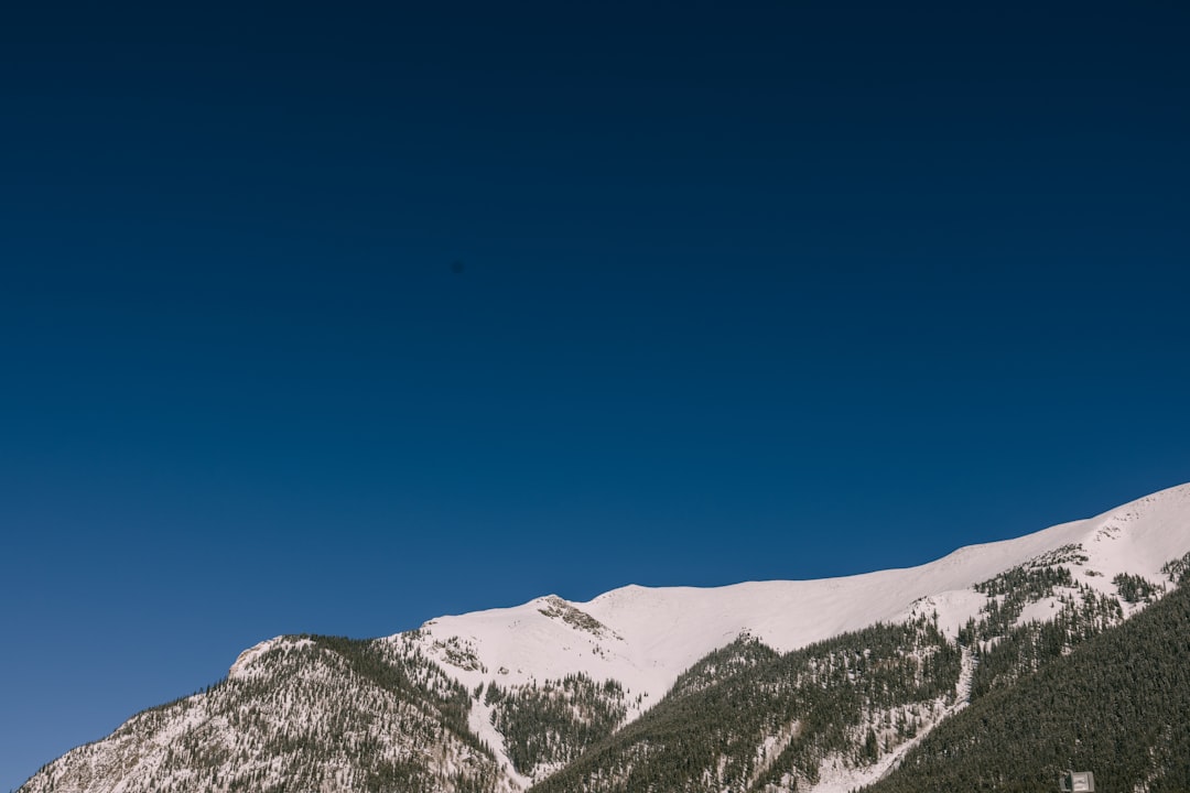 a snowboarder is doing a trick in the air, Mountain views in Colorado