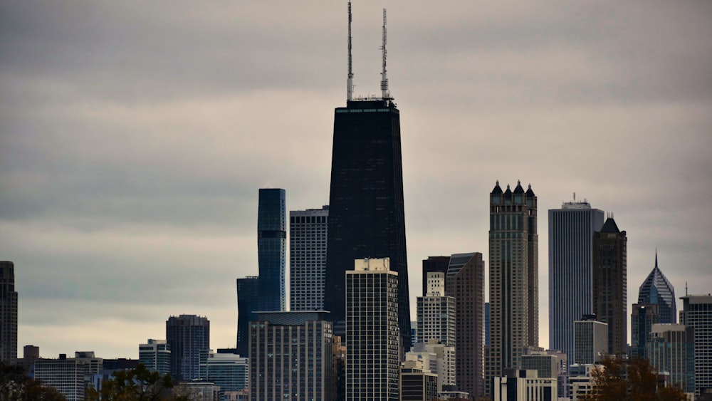 a view of a city skyline with a plane flying in the sky