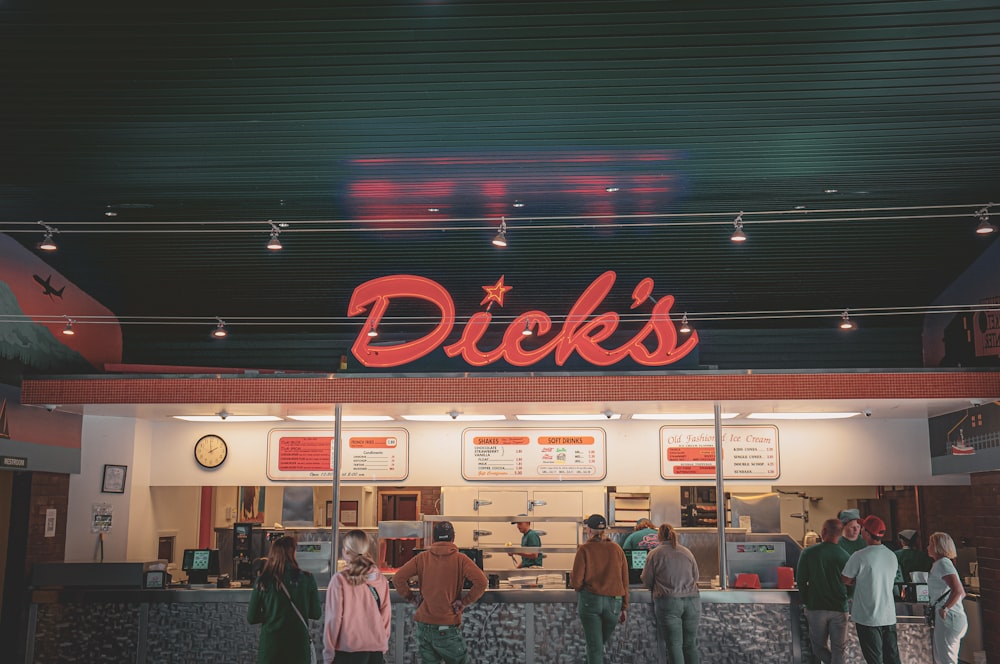 a group of people standing outside of a restaurant