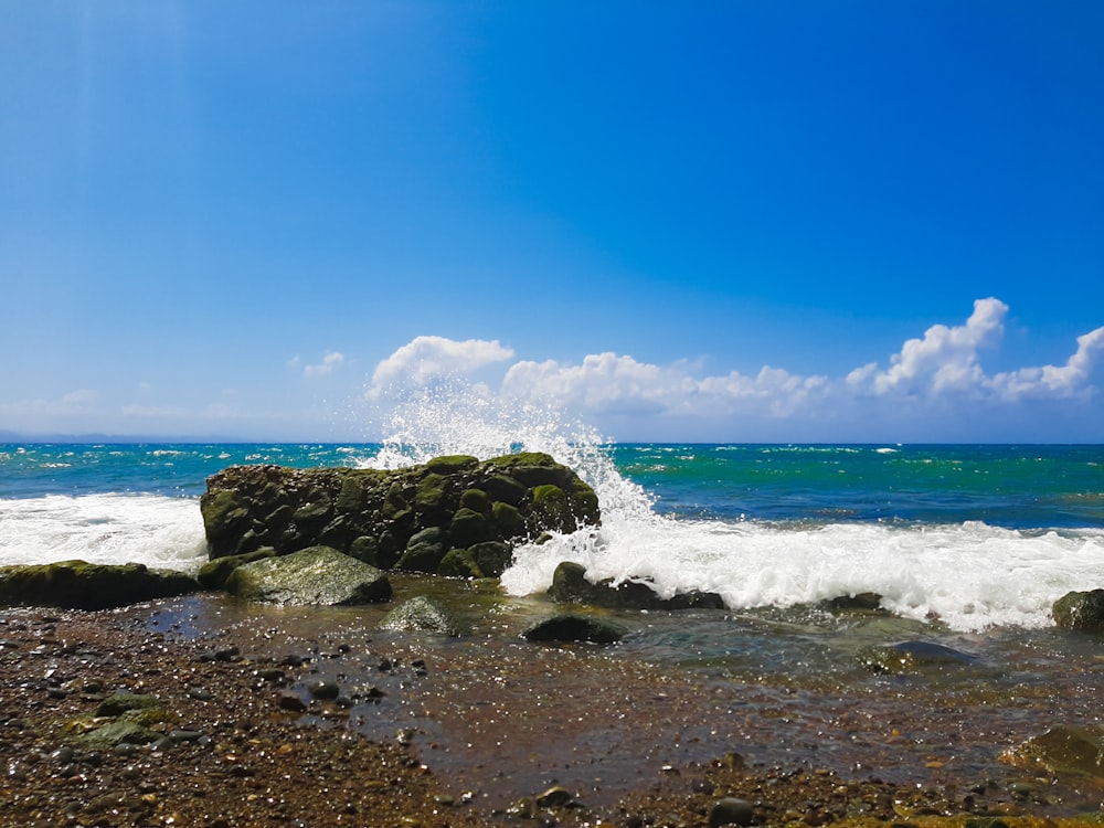 a large rock sticking out of a body of water