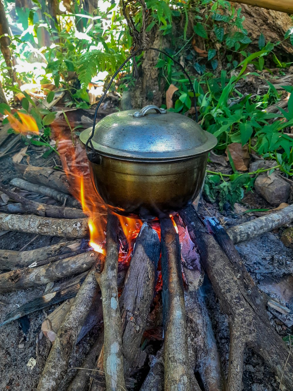 a large pot sitting on top of a fire