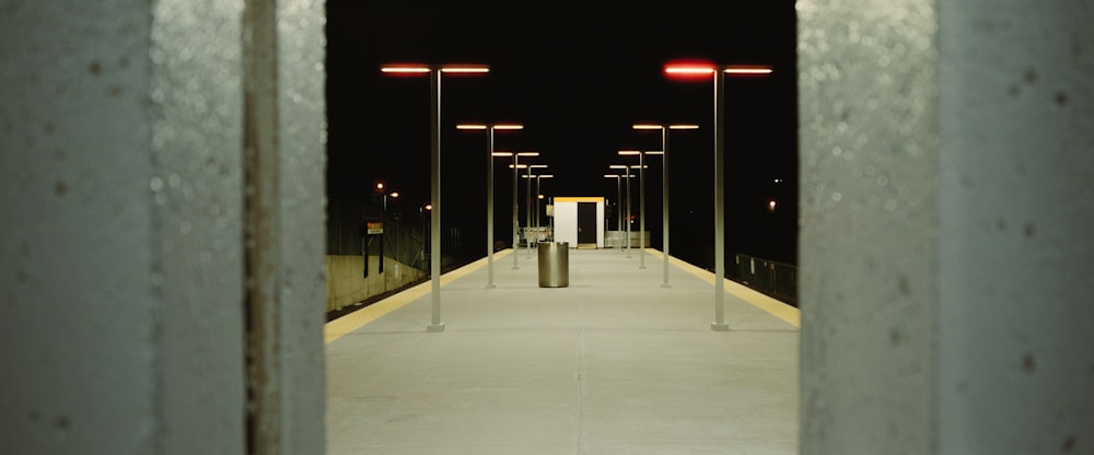 a long walkway with lights on either side of it