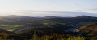 A panoramic view of rolling hills and peaceful homes in Barsana.