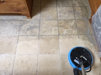 Workers using buffers to polish a large tiled floor