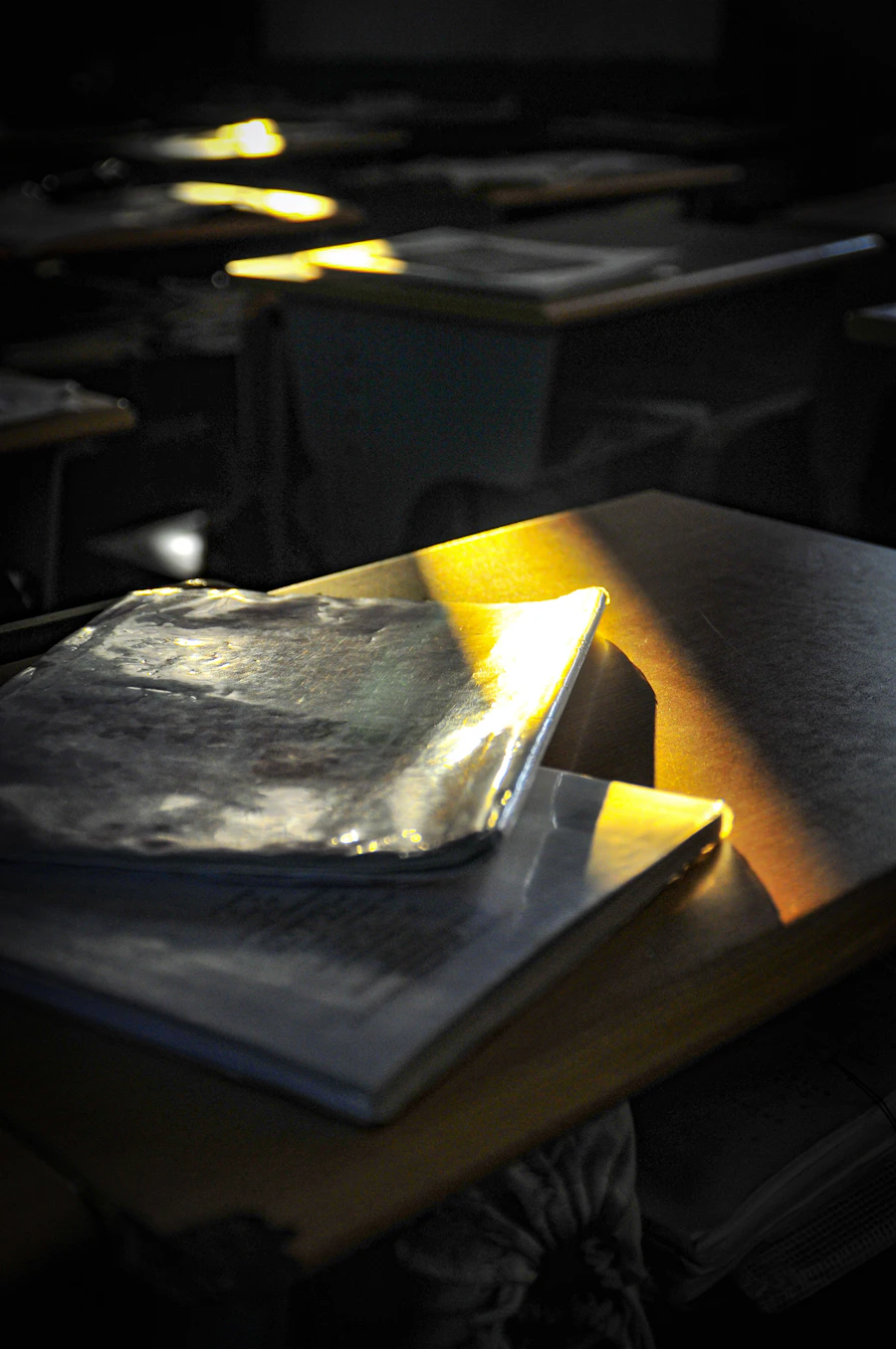 Book and folders on an empty classroom desk