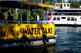 Passengers boarding an eco-friendly water taxi at a busy harbor dock.