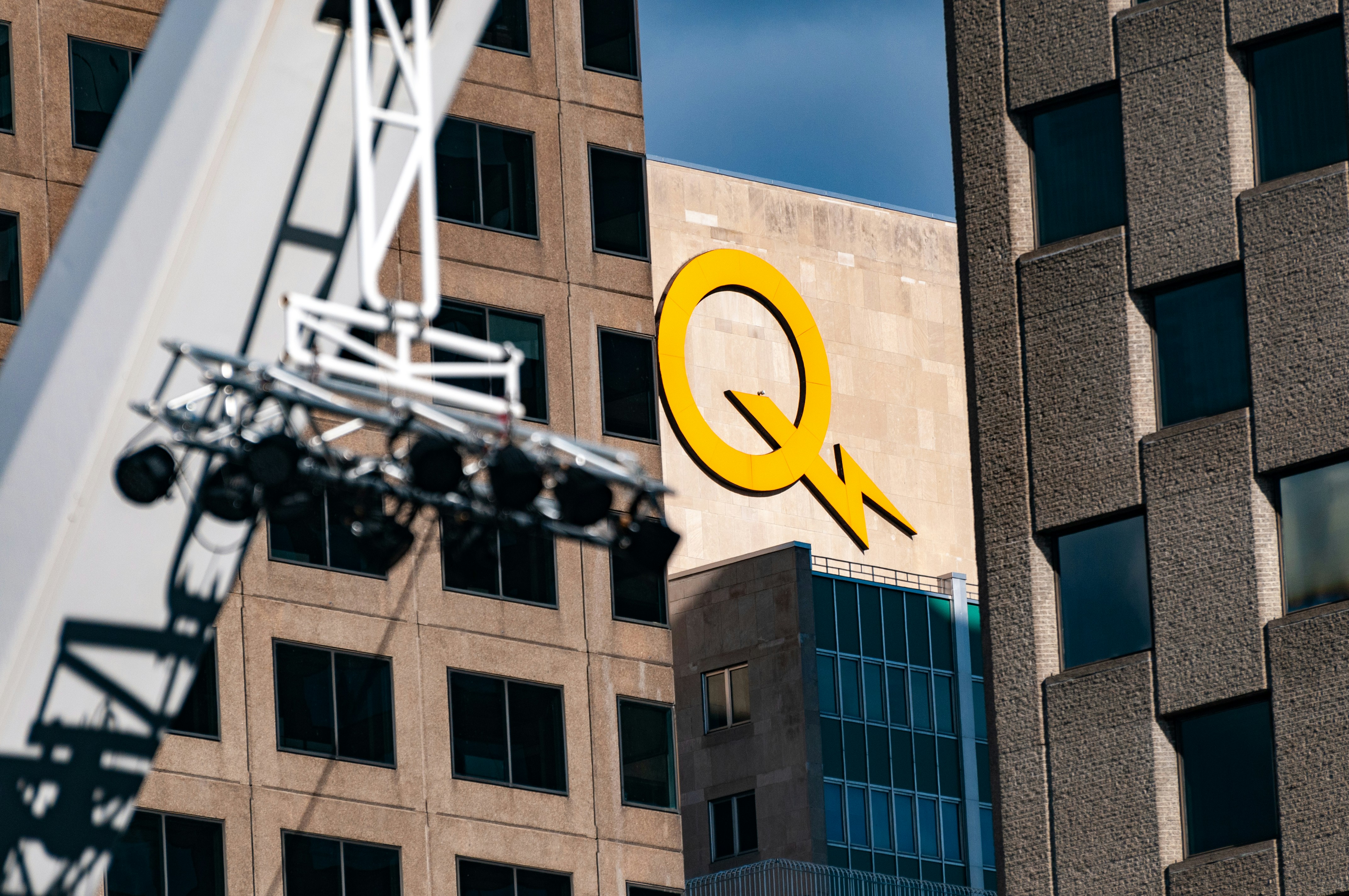 a large yellow q sign on the side of a building