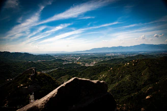 A panoramic view of rolling green hills and ancient stone walls in the English countryside.